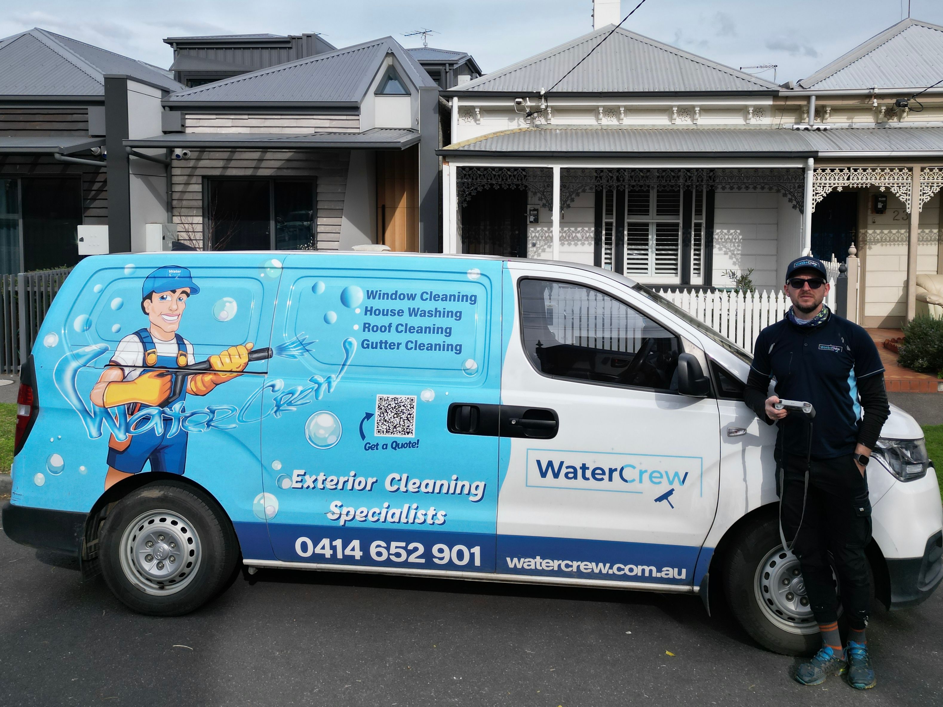 WaterCrew technician with the signwritten van outside a Victorian terrace in Albert Park
