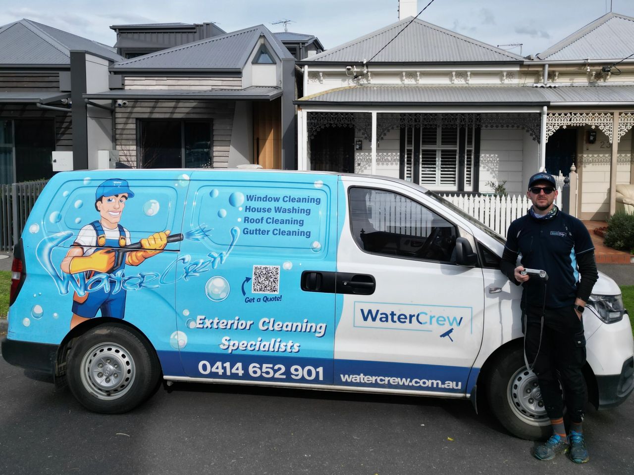 WaterCrew technician with the signwritten van outside a Victorian terrace in Albert Park