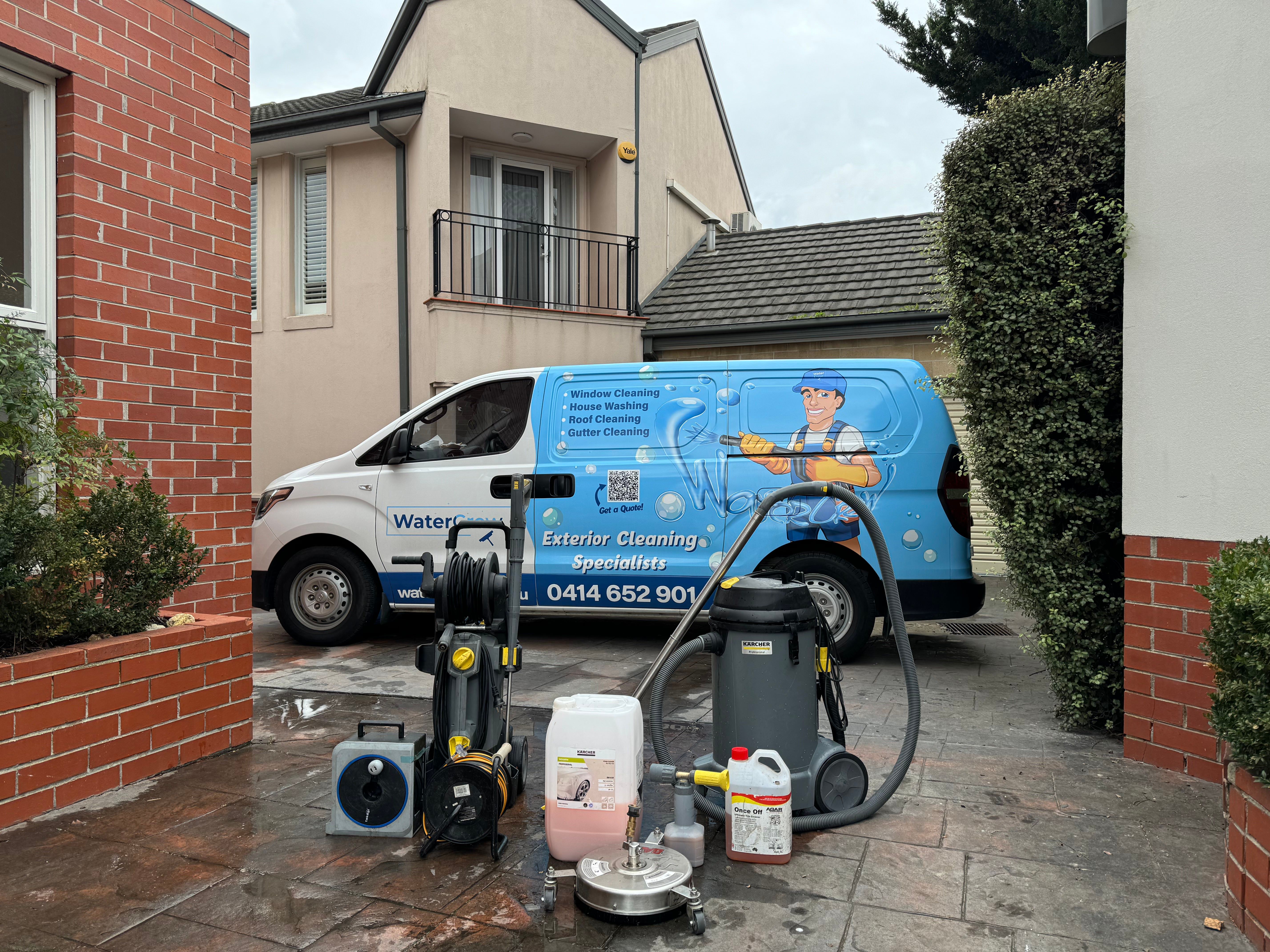 Technician beside the WaterCrew van and equipment on a Brighton East street