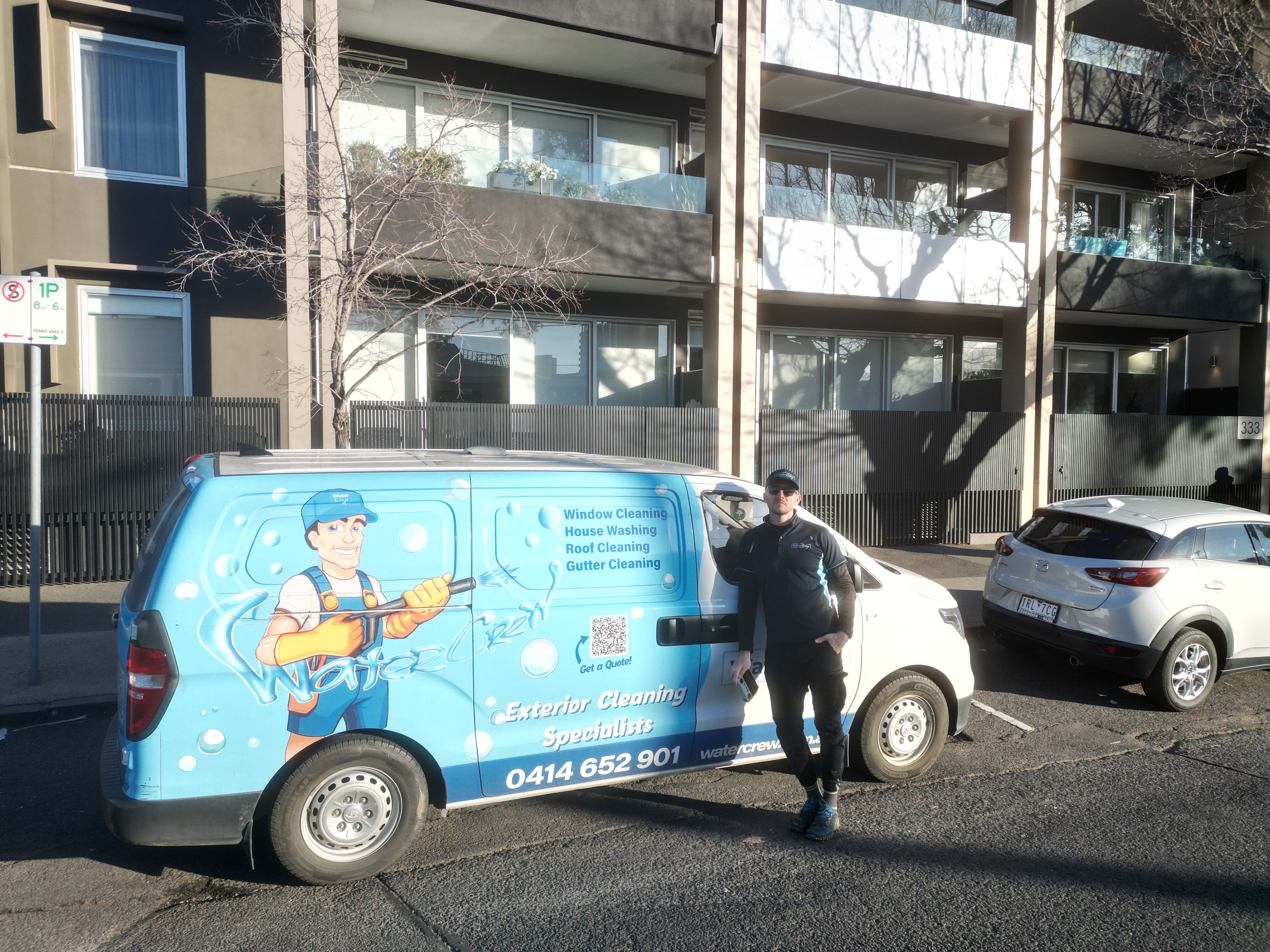 WaterCrew technician cleaning exterior of a Melbourne home
