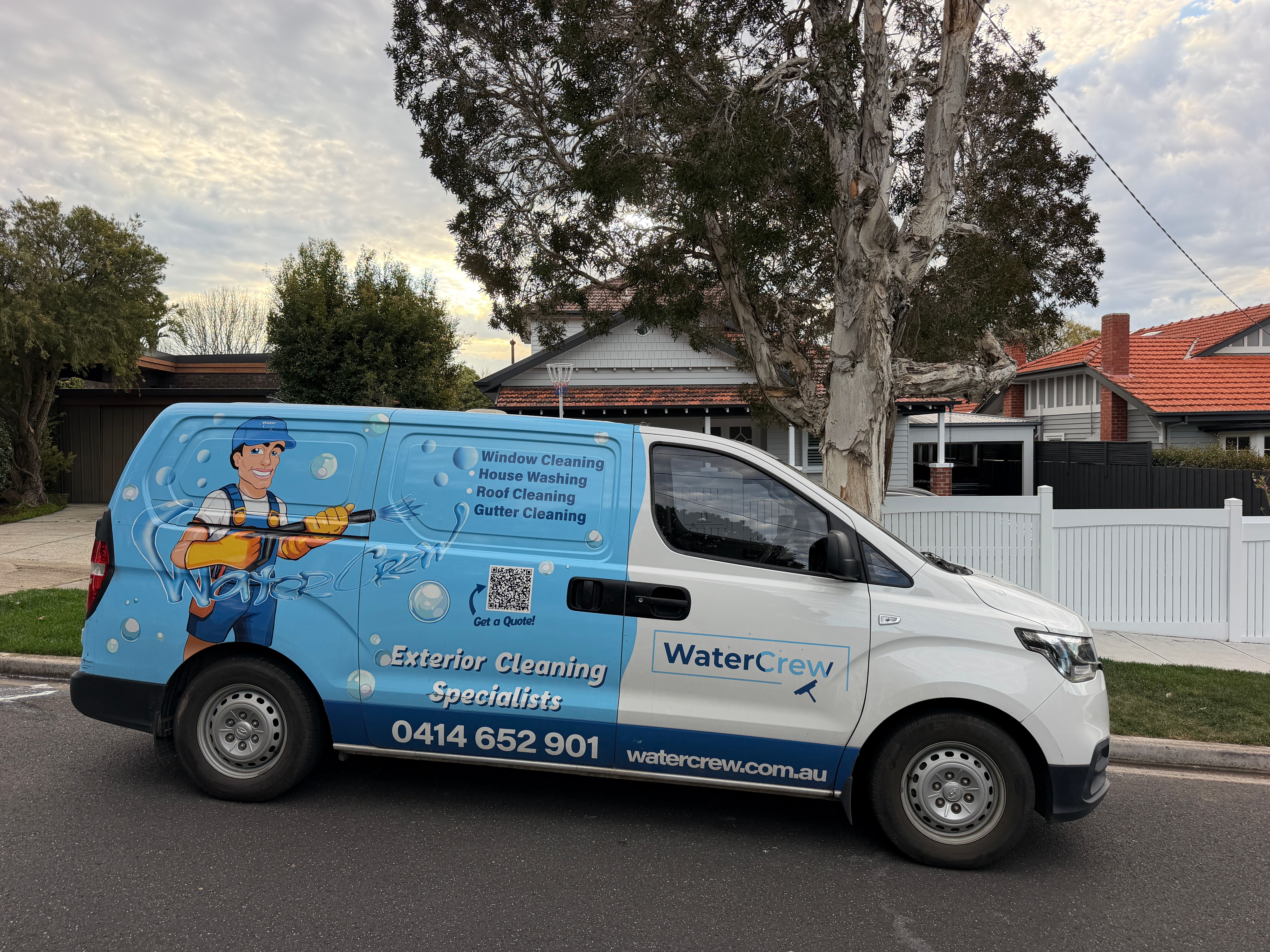 WaterCrew technician and van parked on a McKinnon street of 1930s bungalows
