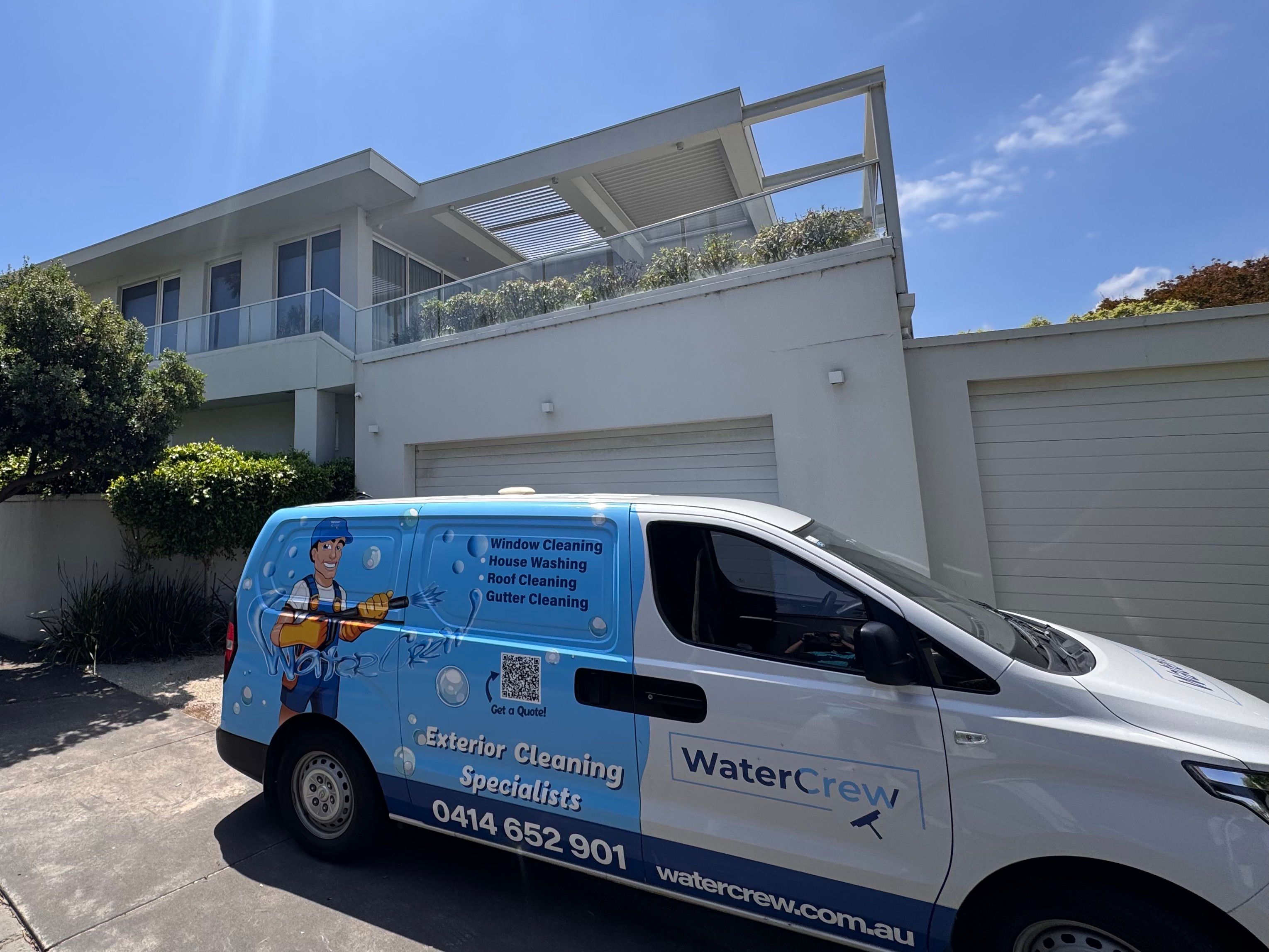 WaterCrew van parked outside a modern two-storey home in Brighton