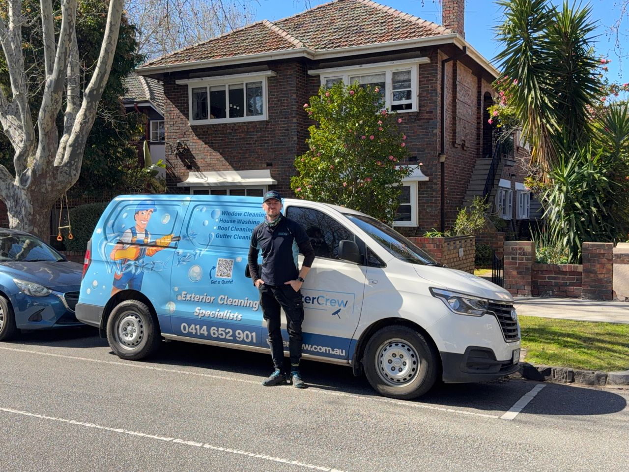 WaterCrew technician cleaning exterior of a Melbourne home
