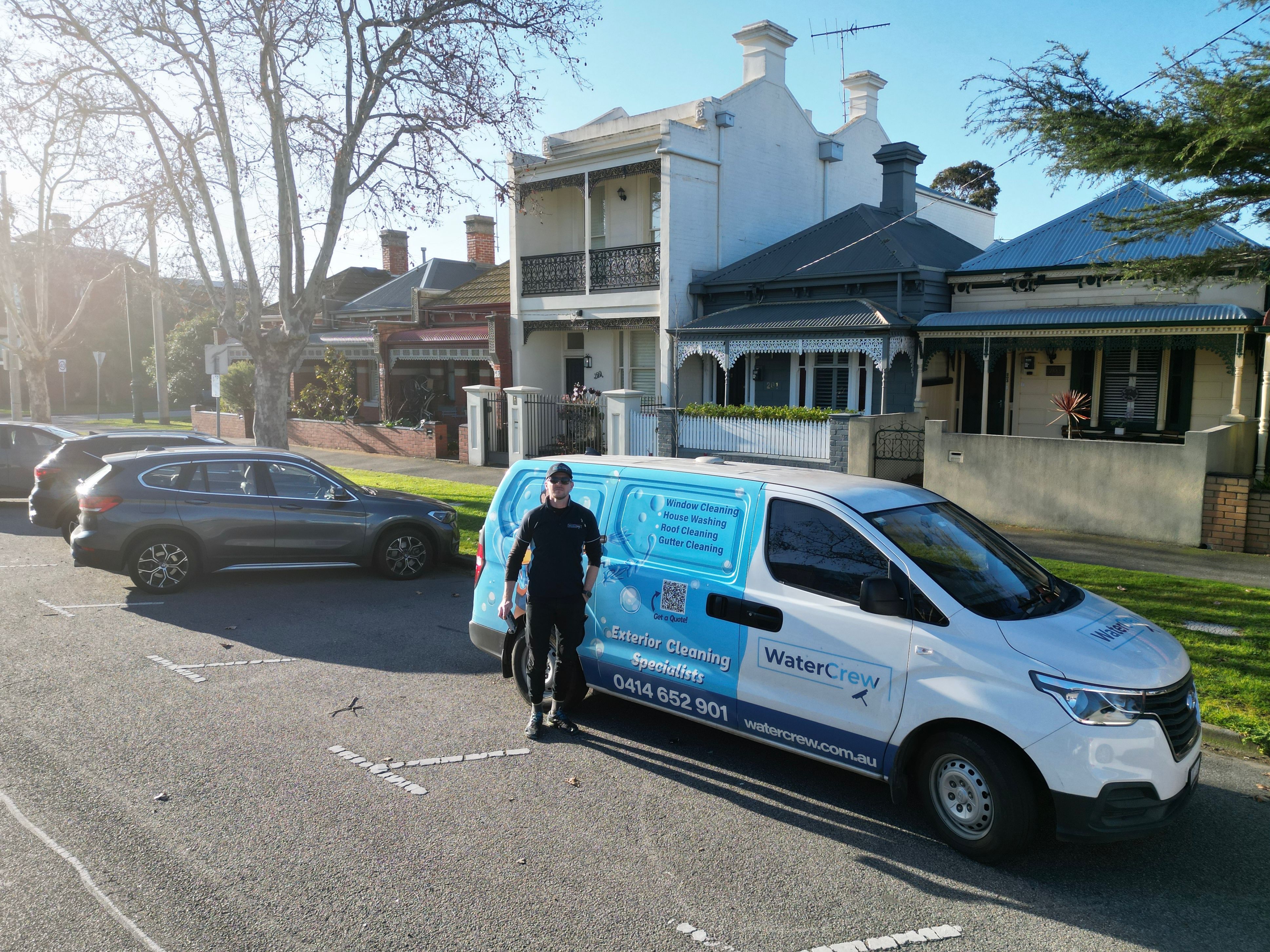 WaterCrew technician cleaning exterior of a Melbourne home
