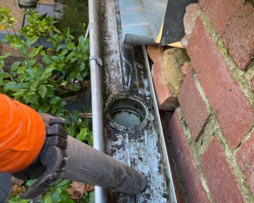 The same Moor Street gutter cleared to bare metal with the outlet open after vacuum cleaning