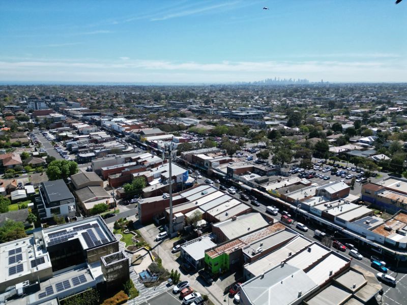 Aerial over Centre Road Bentleigh with tile and Colorbond roofs either side