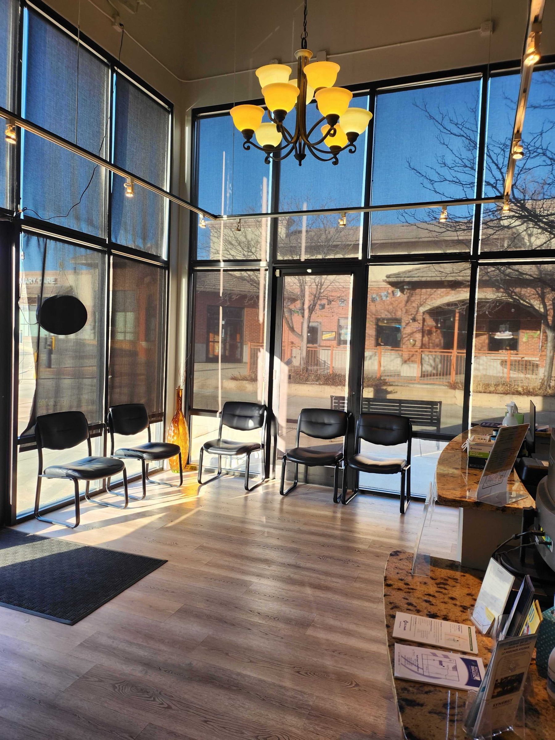 Sunlit lobby with seating and a chandelier