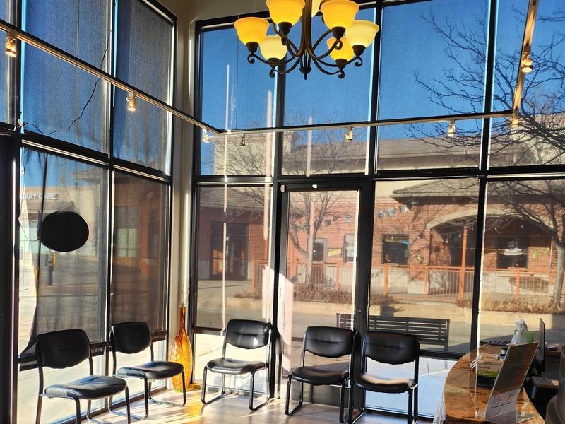 Sunlit lobby with seating and a chandelier