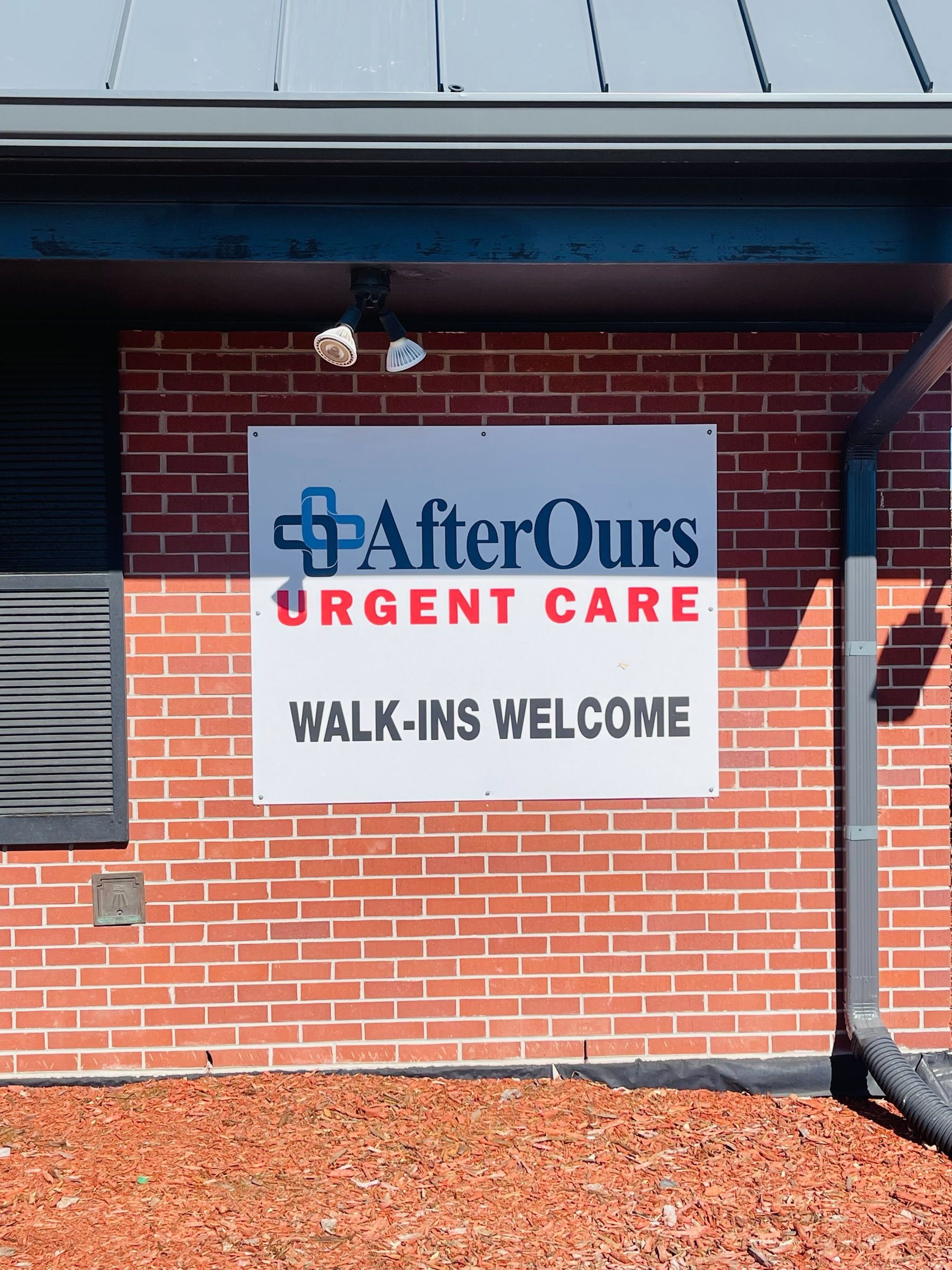 Walk-ins Welcome sign on the brick exterior