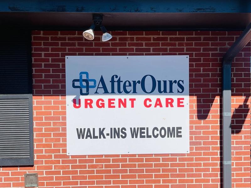 Walk-ins Welcome sign on the brick exterior