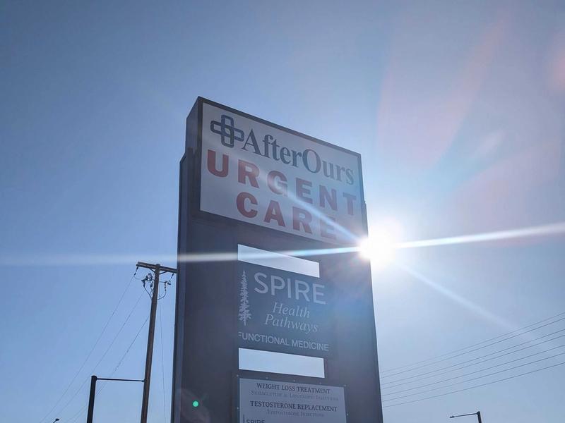 AfterOurs Urgent Care roadside sign in the afternoon sun