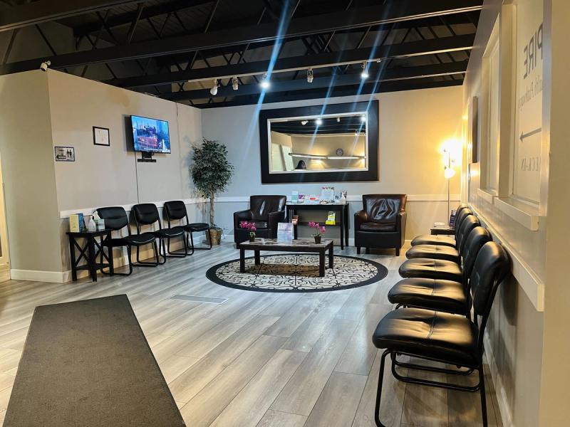 Waiting room with seating and a TV