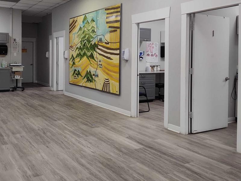 Hallway with colorful artwork and exam rooms