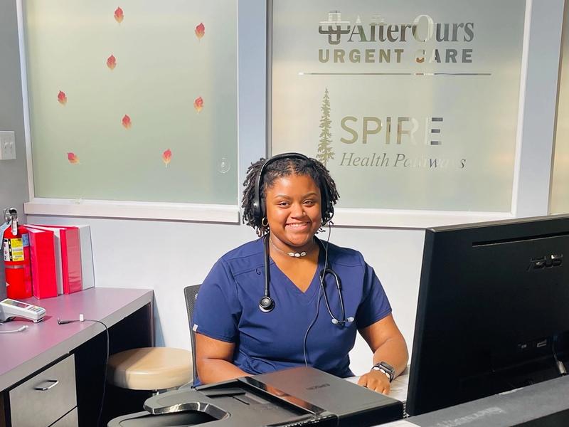 A friendly AfterOurs team member at the front desk in Denver Southeast