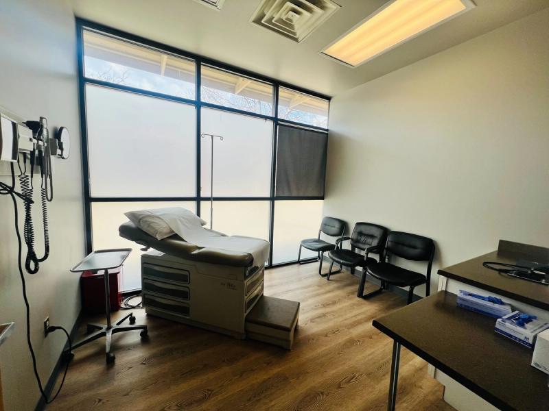 Exam room with a large window and exam table