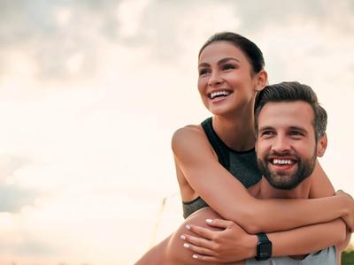 Happy couple outdoors after exercise - representing renewed energy, balanced metabolism, and improved wellbeing through functional medicine treatment for thyroid disorders in Denver, Colorado Springs, and Fort Collins