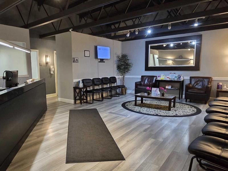 Waiting room and front desk under exposed ceiling beams