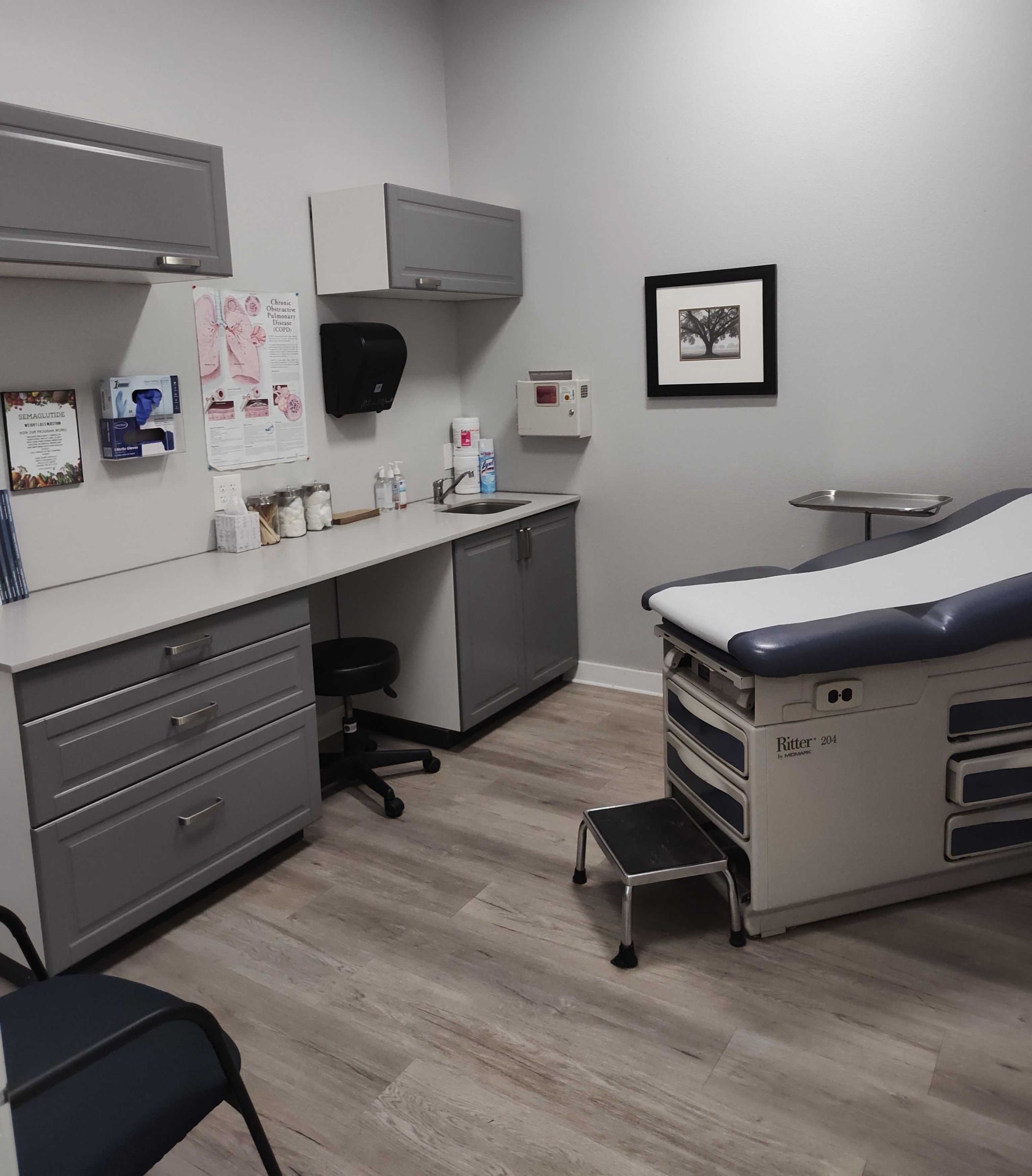 Exam room with a cabinet, sink and exam table
