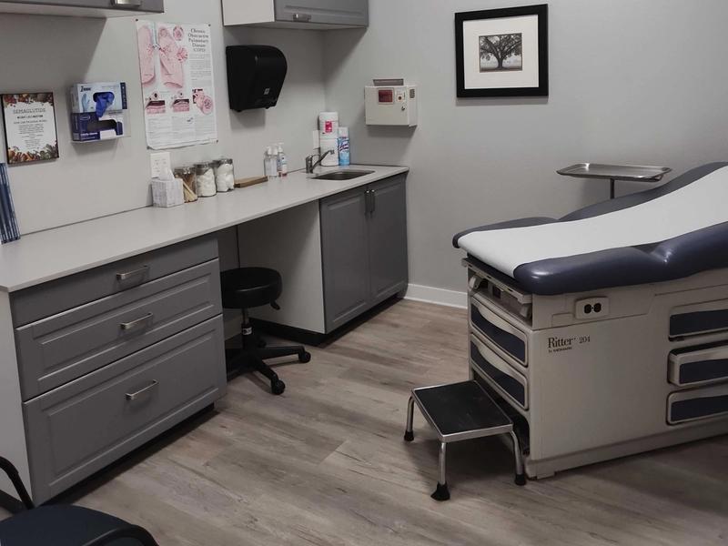 Exam room with a cabinet, sink and exam table