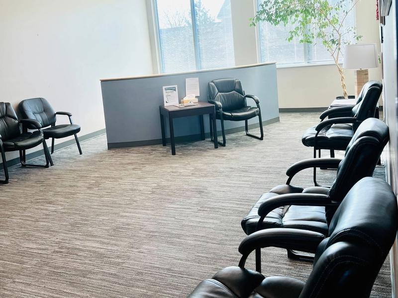Waiting room with leather chairs and a large window