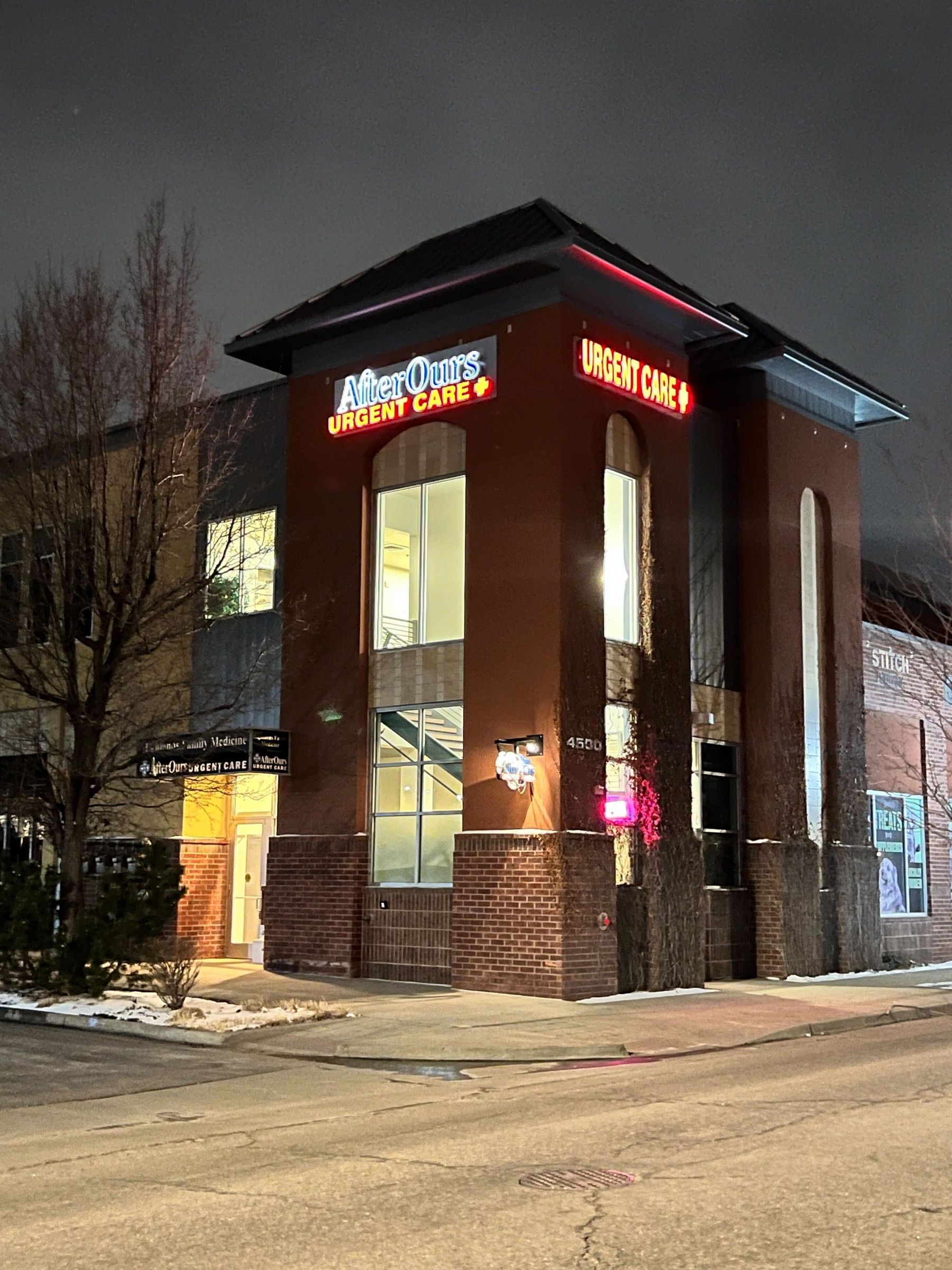 AfterOurs Denver Highlands entrance lit up at night