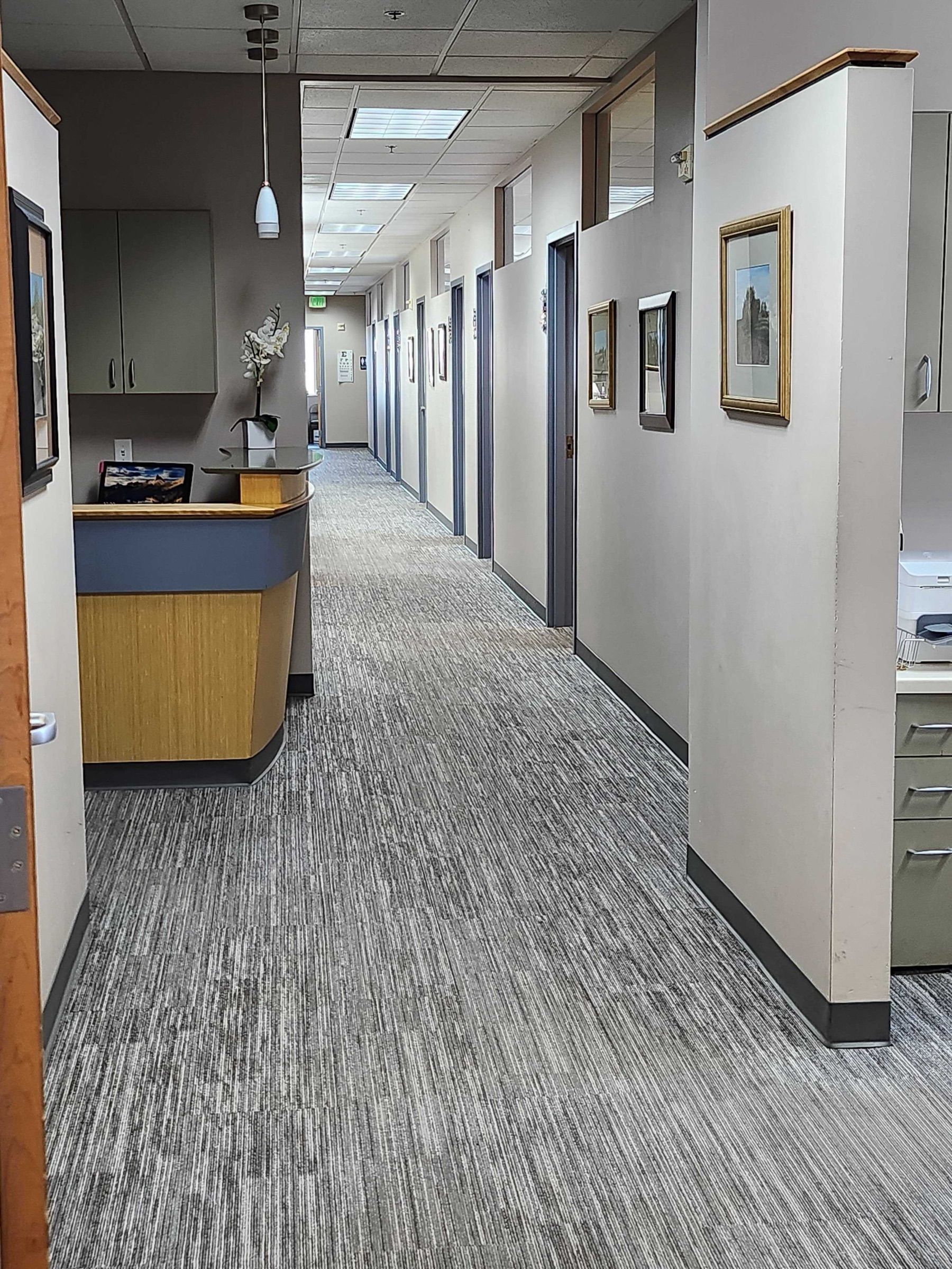Hallway with exam rooms behind the front desk