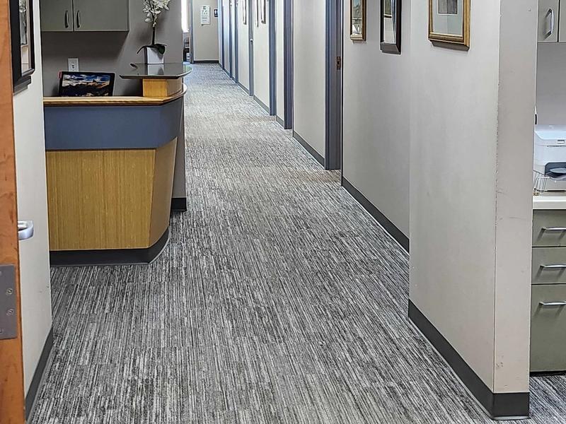 Hallway with exam rooms behind the front desk