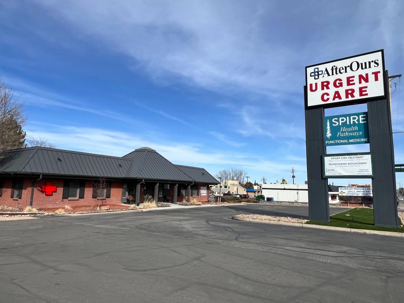 AfterOurs Urgent Care Denver Southeast: brick clinic building and street sign on Hampden Avenue