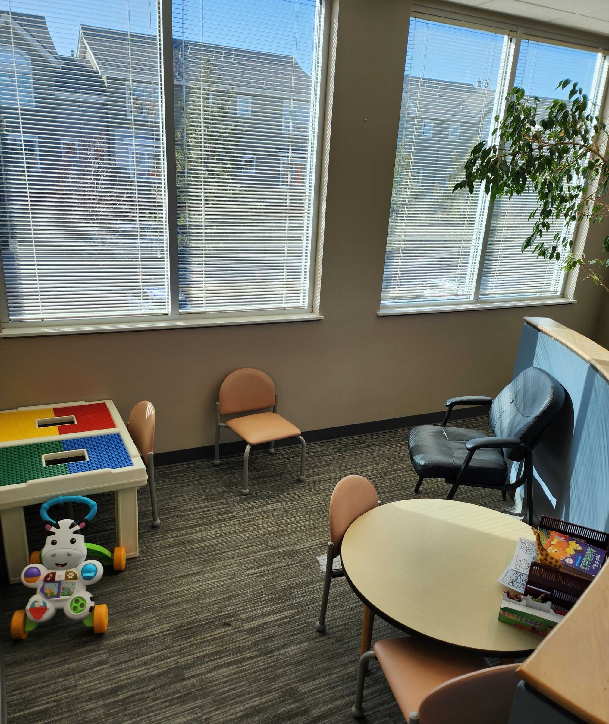 Family waiting corner with toys and a play table