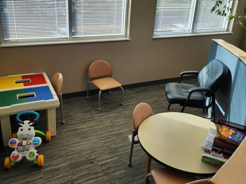 Family waiting corner with toys and a play table