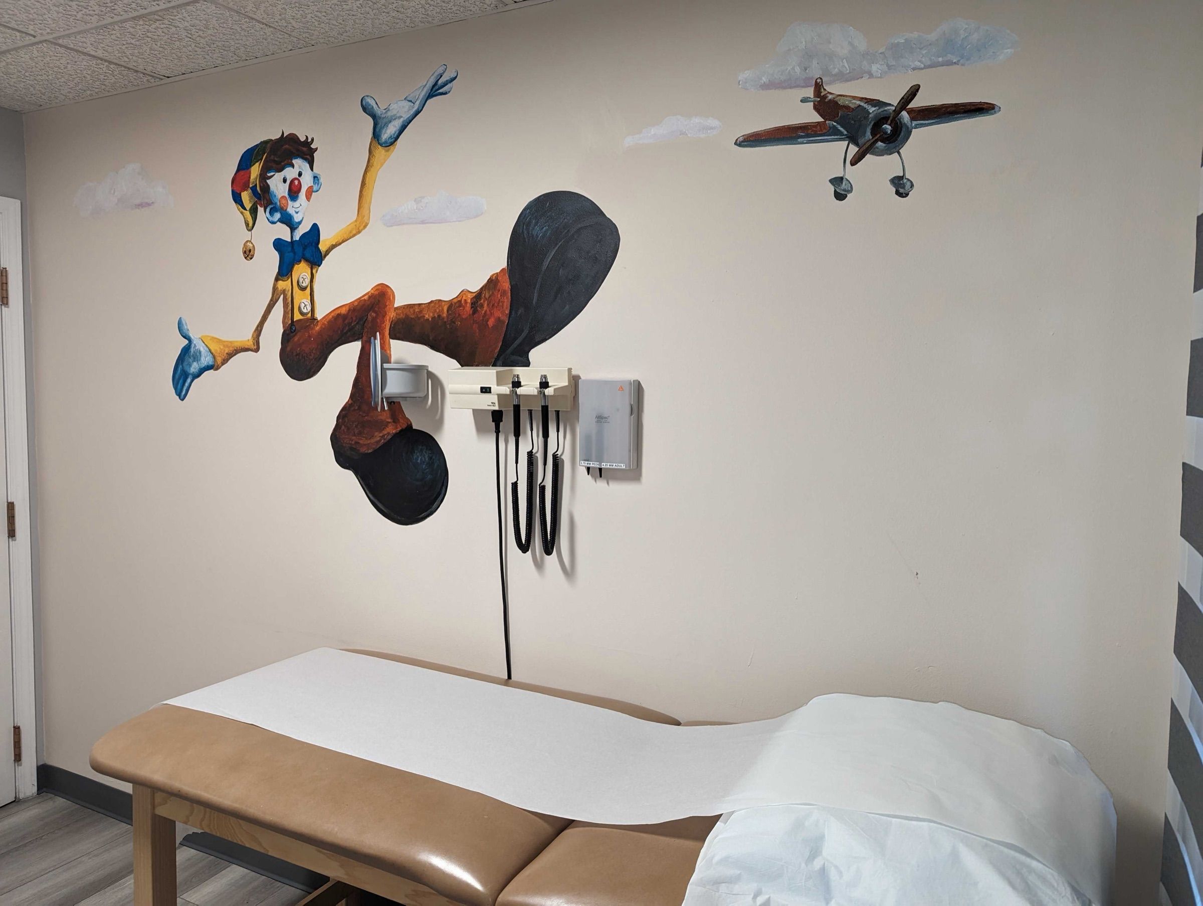 Pediatric exam room with a hand-painted wall mural
