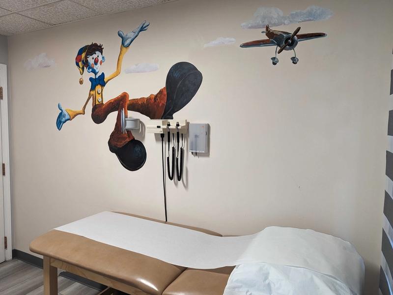 Pediatric exam room with a hand-painted wall mural