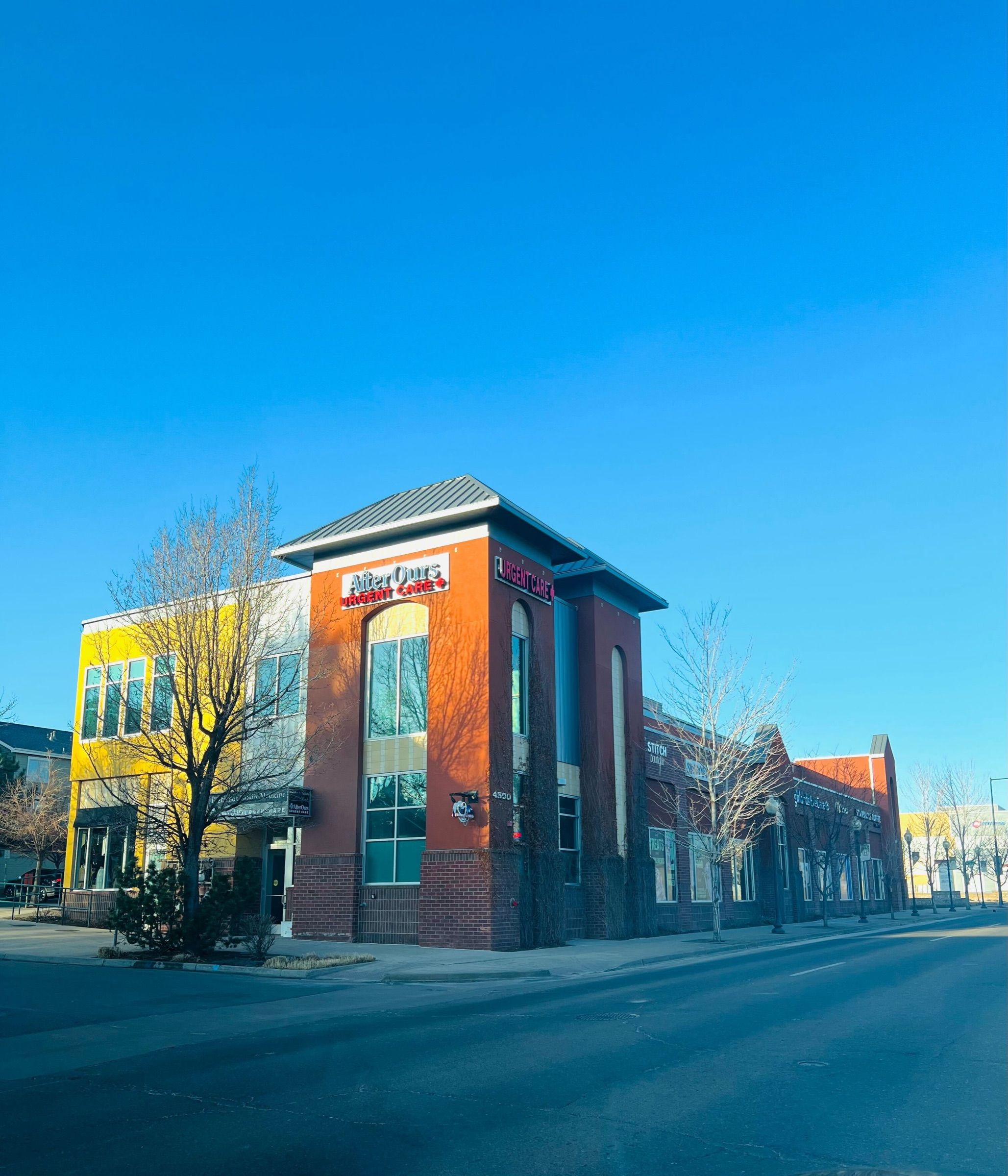 AfterOurs Denver Highlands building on a clear blue-sky morning