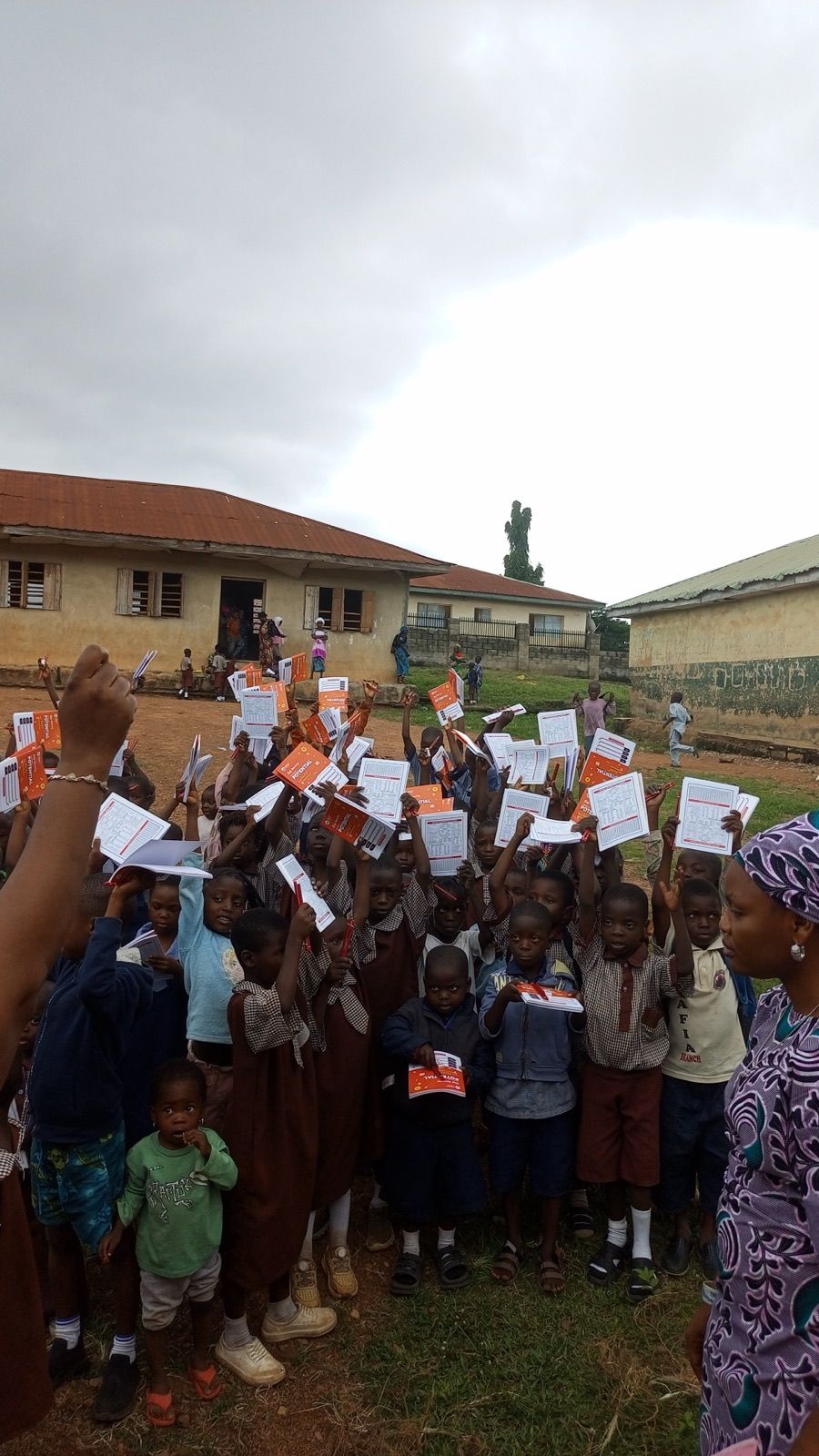 Pupils holding up their new notebooks