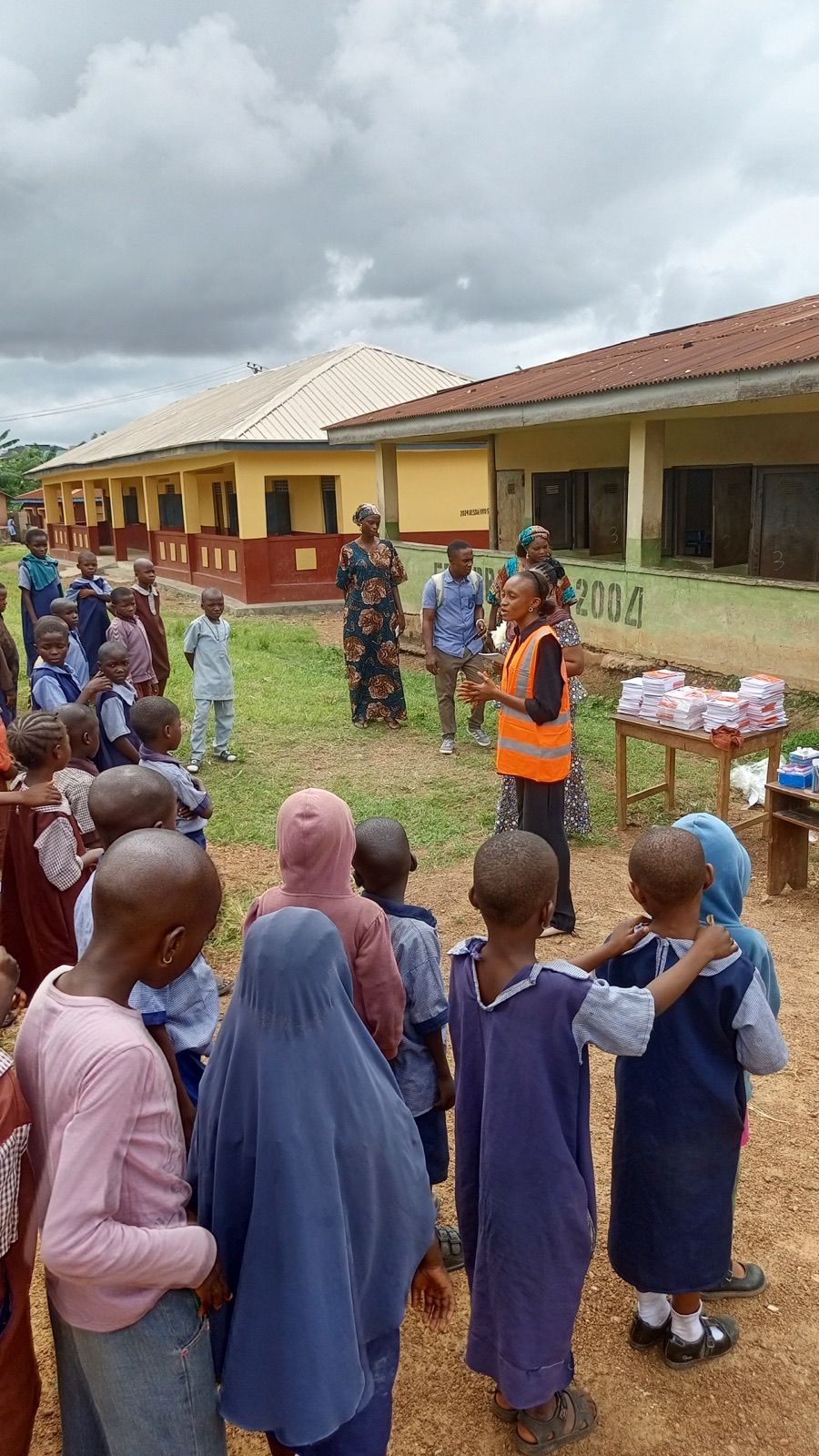 Pupils gathered at the distribution table with a volunteer