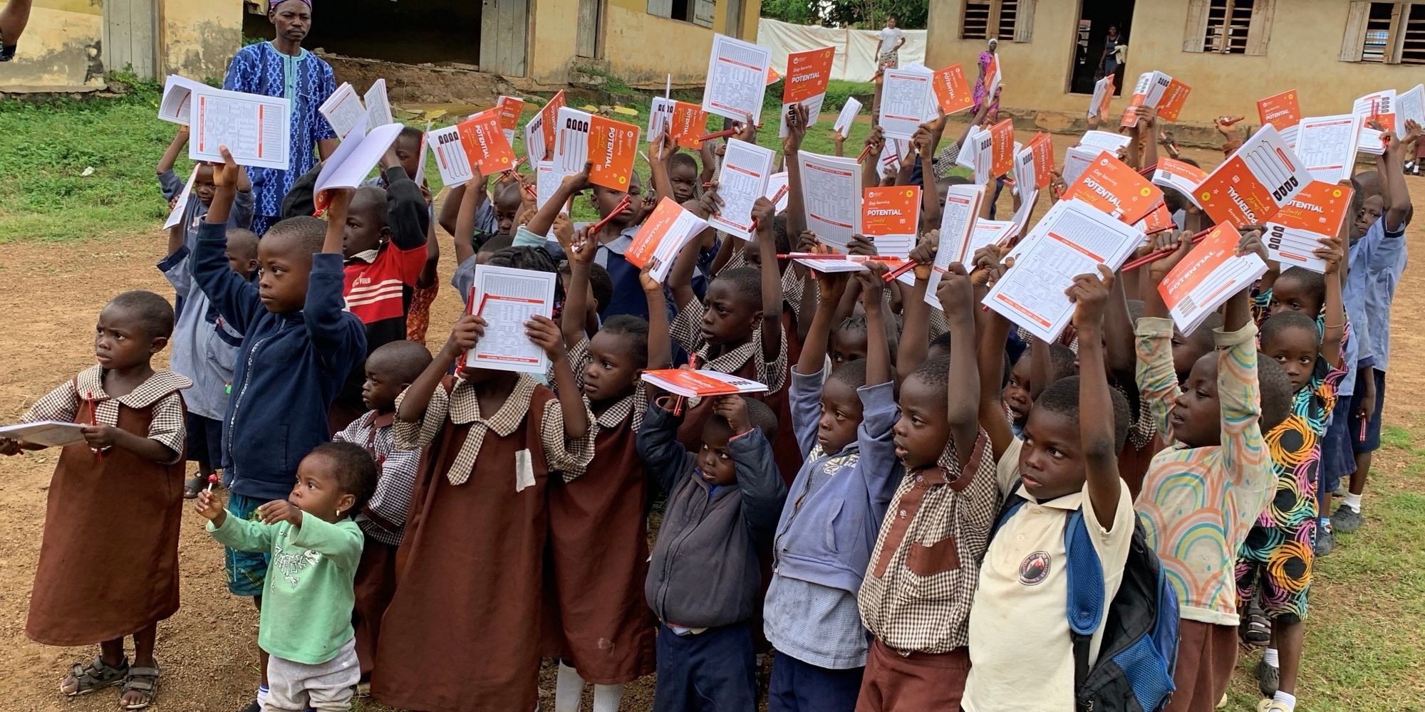 Pupils in Oyo State holding up their new notebooks