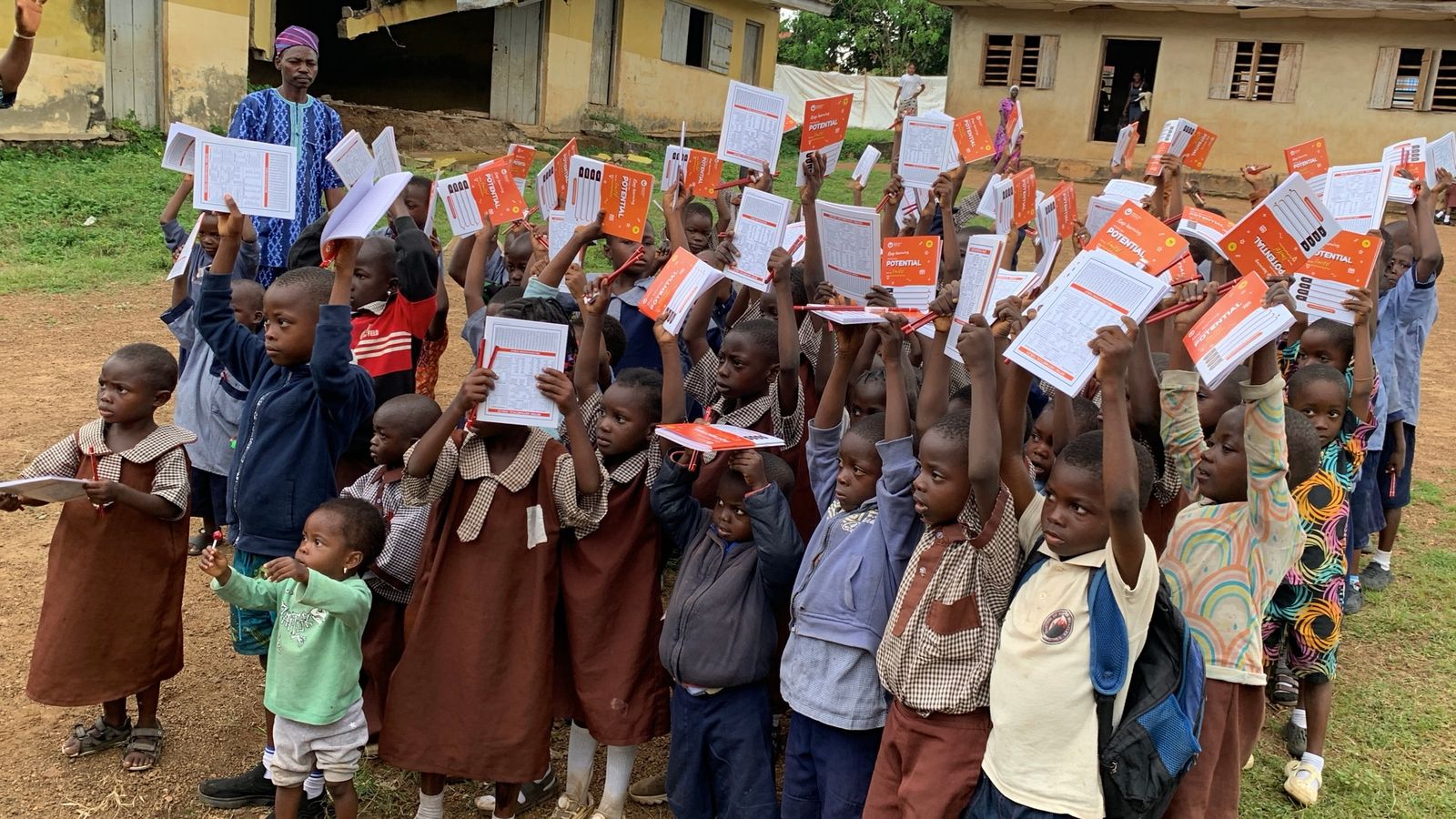Pupils in Oyo State holding up their new notebooks