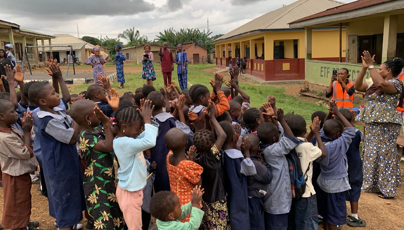 Pupils cheering with their hands raised