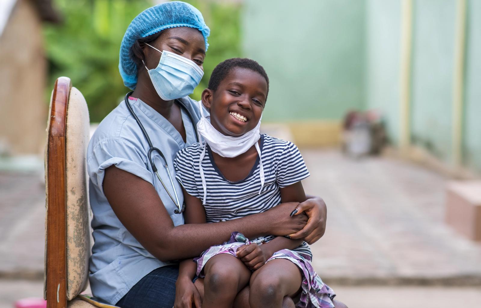 A community health worker meeting with a family