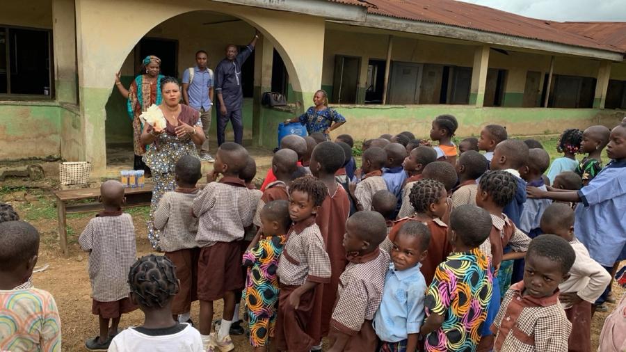 Pupils gathering around Foundation volunteers in the schoolyard