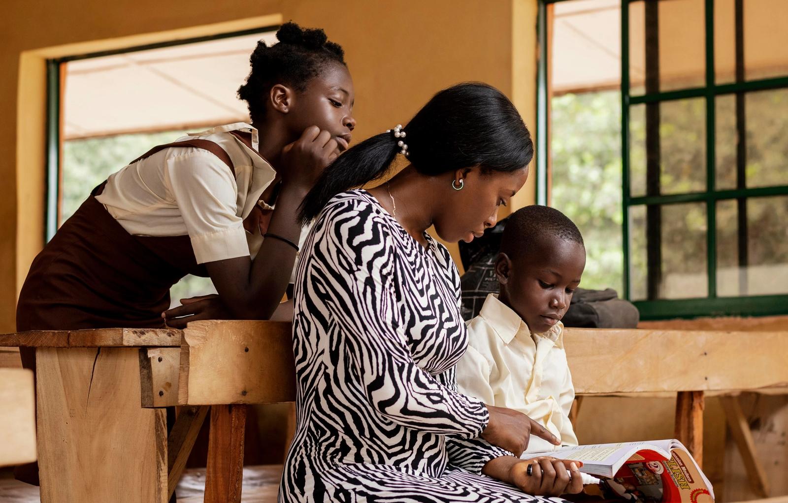 A teacher supporting students in a classroom