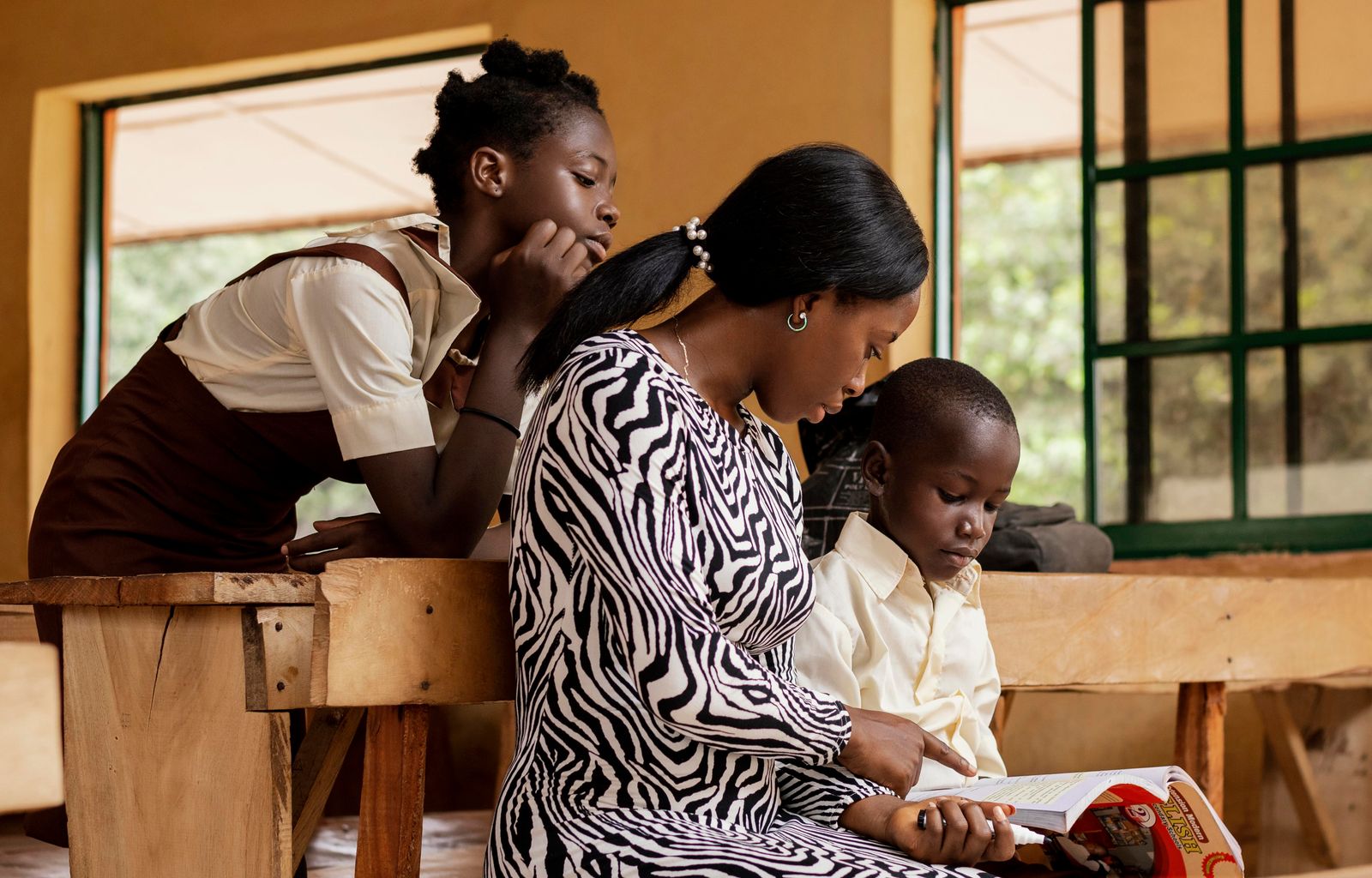 A teacher supporting students in a classroom
