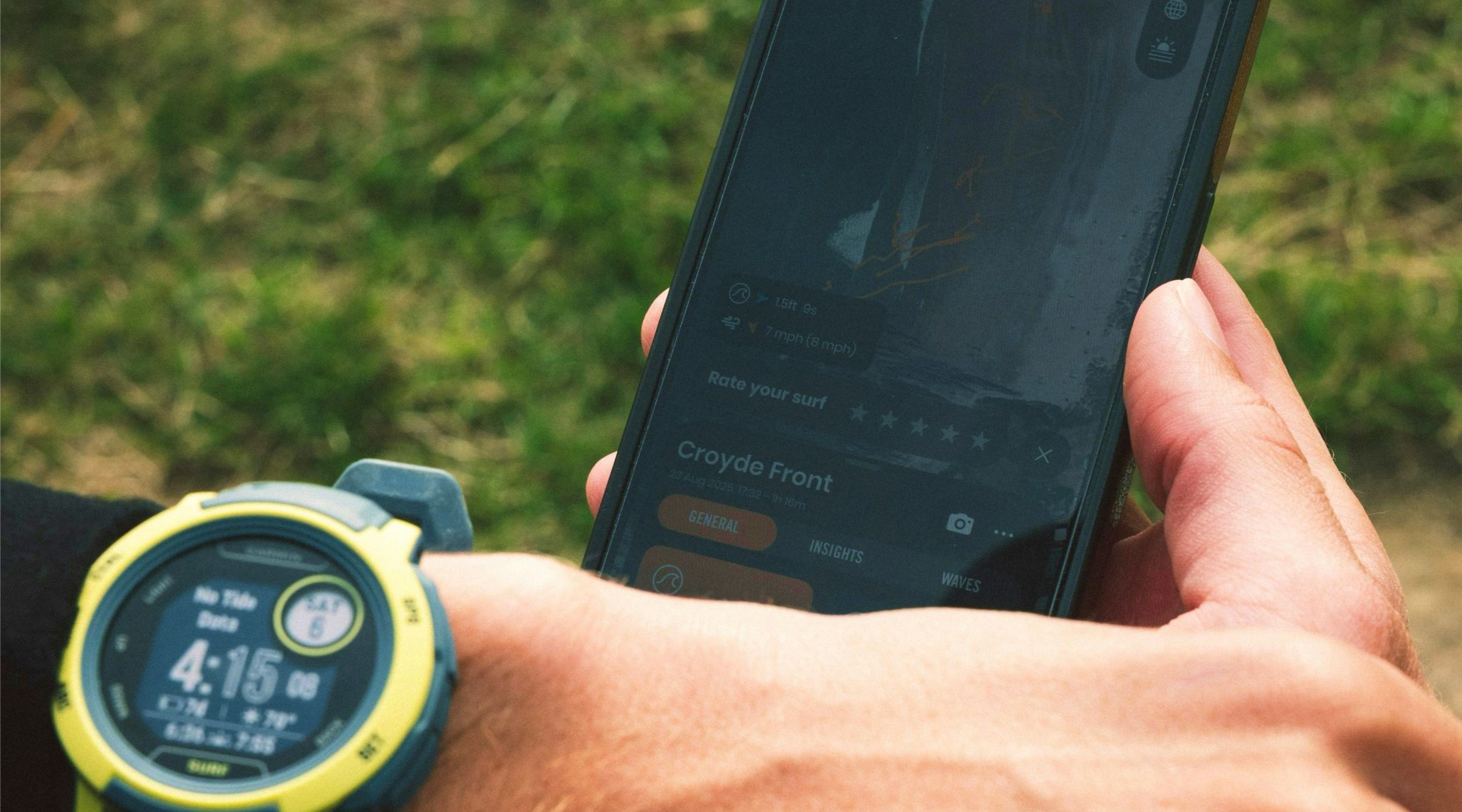 Athlete reviewing wearable and performance data on phone and smartwatch after training
