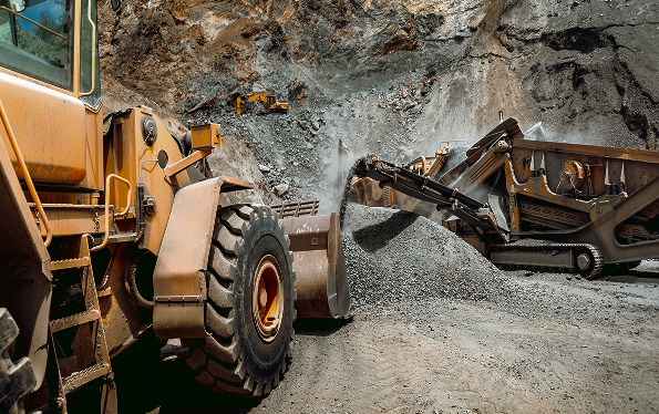 Heavy mining equipment working an open-pit site