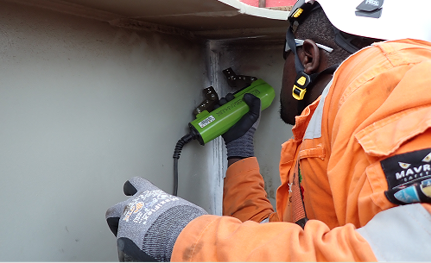 Technician performing non-destructive testing on pipework