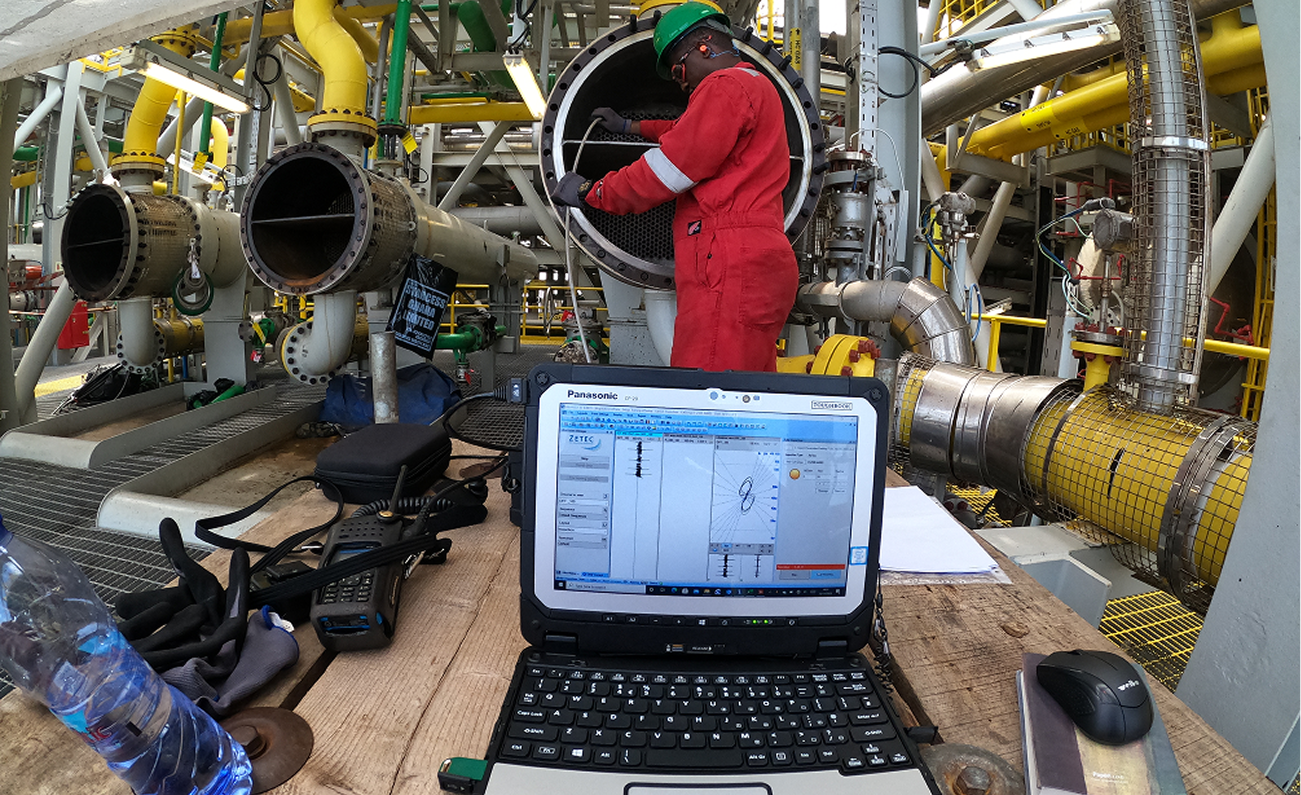 Technician performing eddy current tube inspection onsite