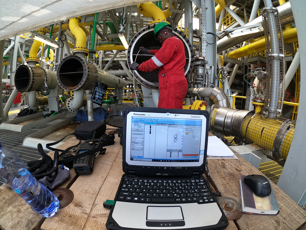 Technician performing eddy current tube inspection onsite