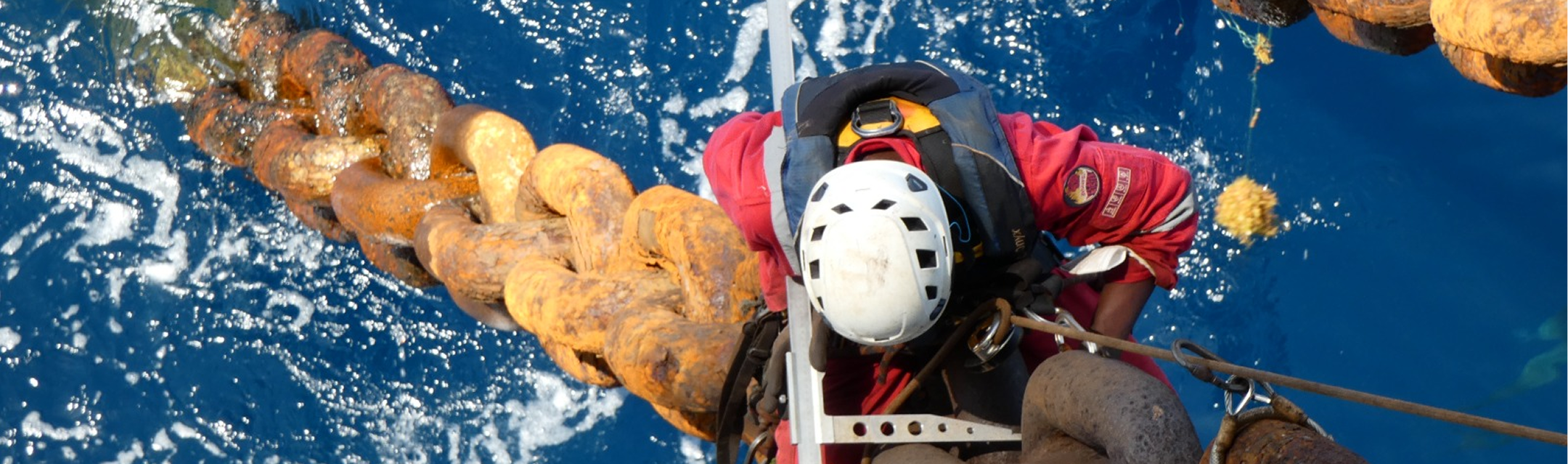 Rope access technician working at height on an industrial structure