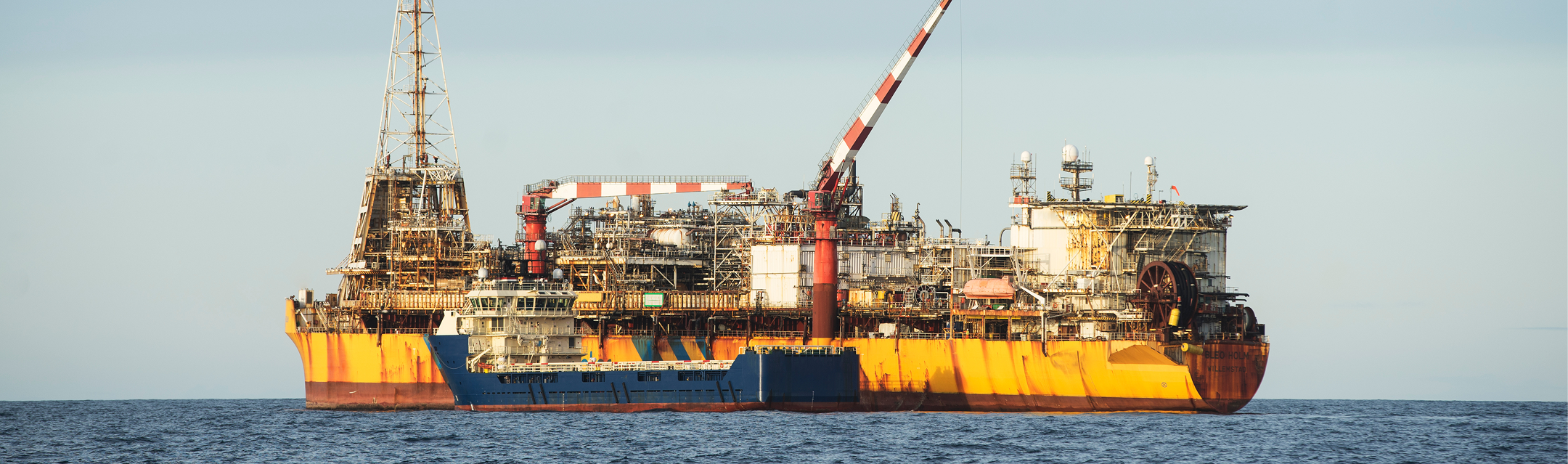 Offshore FPSO production vessel with a support boat alongside