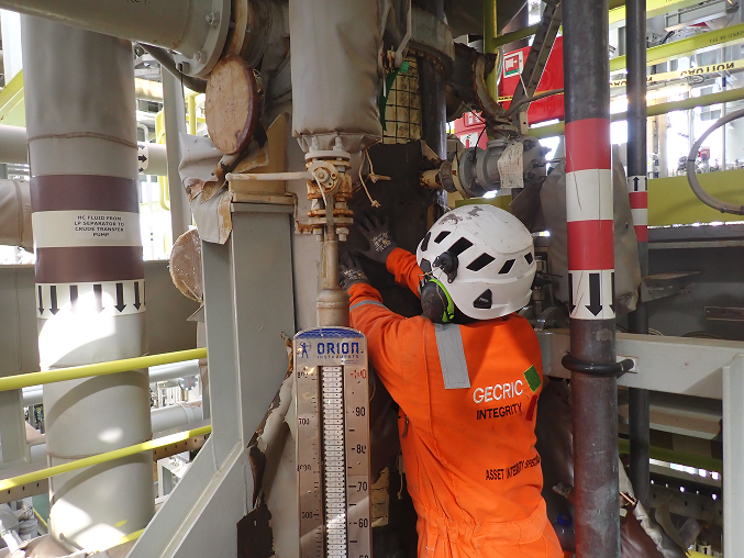 Integrity specialist inspecting industrial equipment